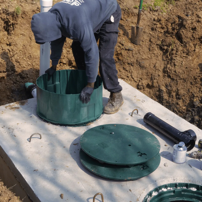man installing sewer caps